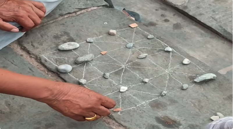 Traditional Baghchal board and pieces